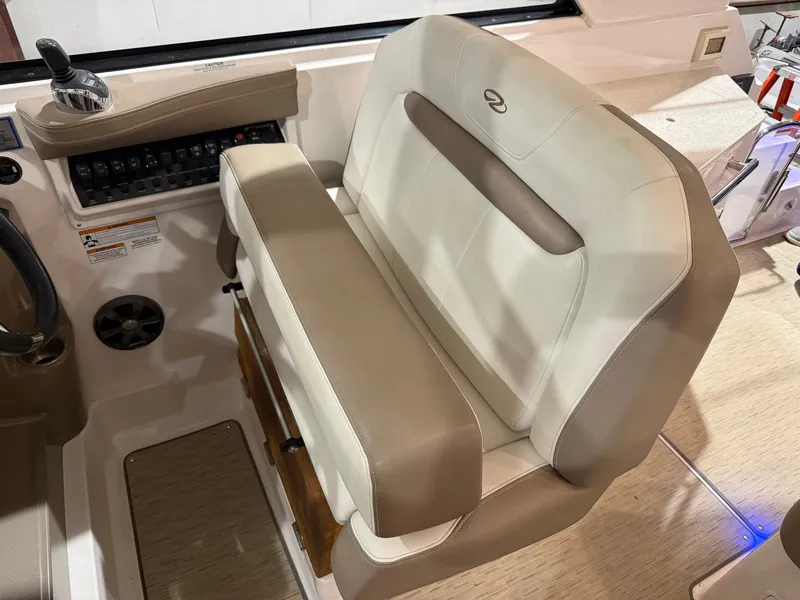 Slide: The Image of The image shows the helm of a 2018 Regal 35 Sport Coupe with a beige upholstered seat. - 27