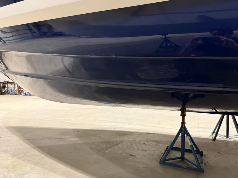 Slide: The Image of Close-up of the hull of a 2018 Regal 35 Sport Coupe on stands. - 18