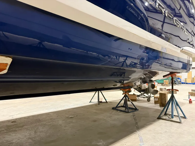 Slide: The Image of A 2018 Regal 35 Sport Coupe is supported on stands in a warehouse. - 17