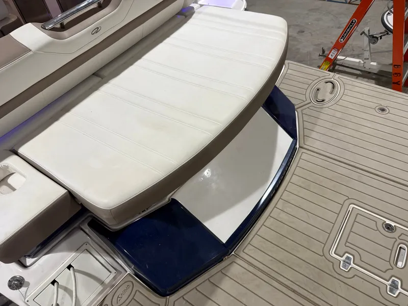 Slide: The Image of The image shows the stern of a 2018 Regal 35 Sport Coupe with a white bench seat and teak flooring. - 20