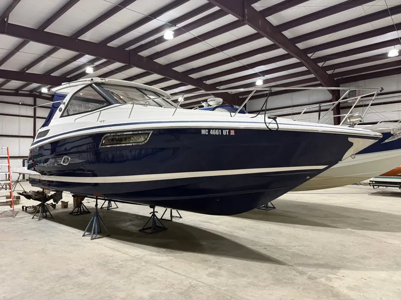 The Image of A 2018 Regal 35 Sport Coupe is on stands in a warehouse. - 0