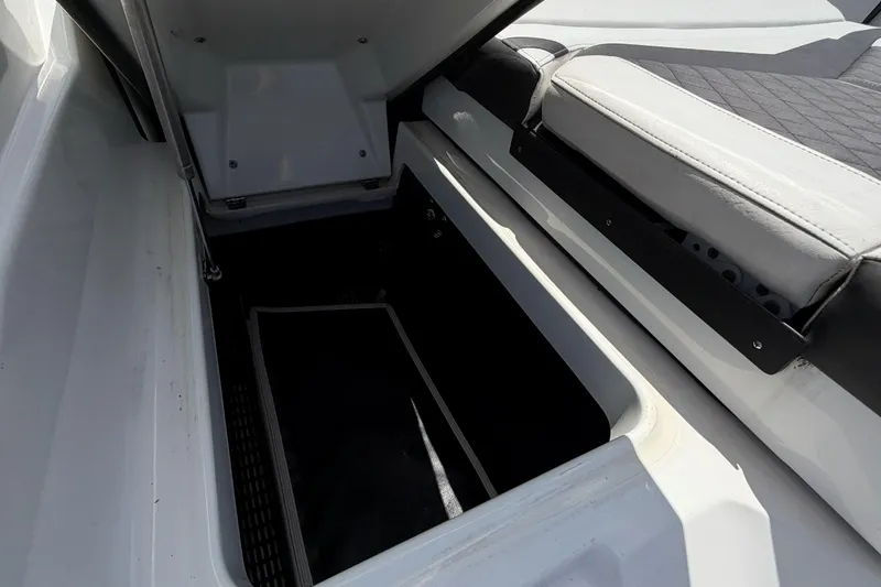 Slide: The Image of Open storage compartment in 2023 Monterey 238SS Super Sport boat. - 17