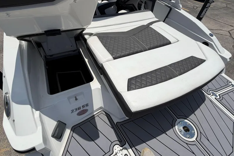 Slide: The Image of 2023 Monterey 238SS Super Sport boat with open storage compartment and cushioned seating. - 16