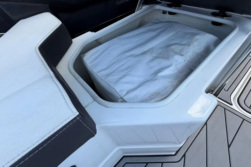Slide: The Image of 2023 Monterey 238SS Super Sport boat storage compartment with cushioned seating. - 29