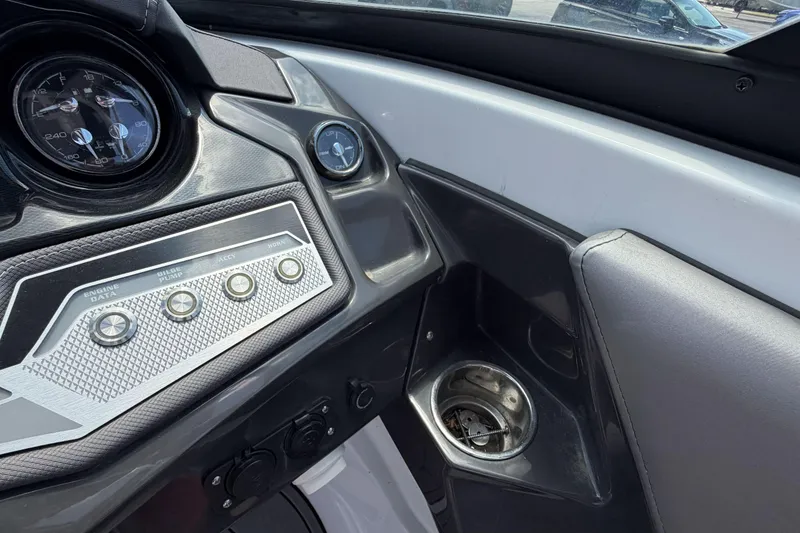 Slide: The Image of Dashboard of 2023 Monterey 238SS Super Sport boat with controls and cup holder. - 34
