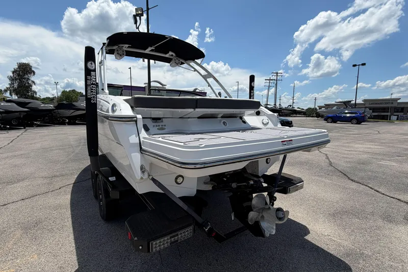Slide: The Image of 2023 Monterey 238SS Super Sport boat in a parking lot under a blue sky. - 2