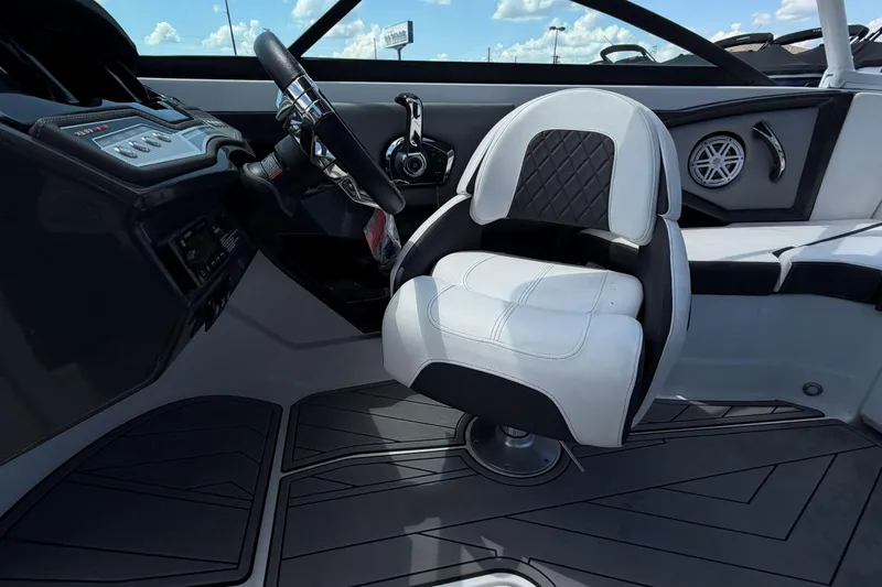 Slide: The Image of Interior of 2023 Monterey 238SS Super Sport boat with sleek steering and cushioned seating. - 26