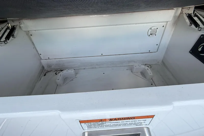 Slide: The Image of Open storage compartment in 2023 Monterey 238SS Super Sport boat. - 28