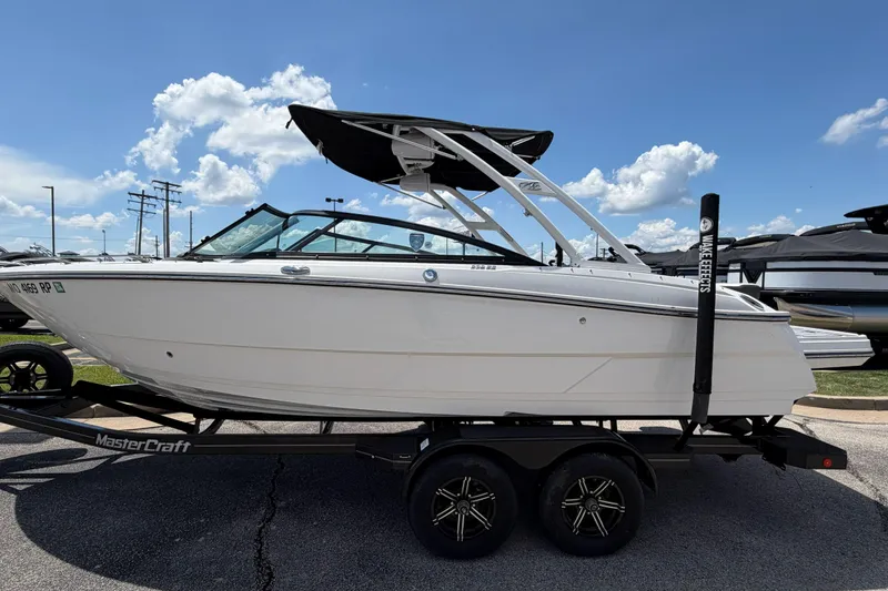 The Image of 2023 Monterey 238SS Super Sport boat on trailer under clear blue sky. - 1