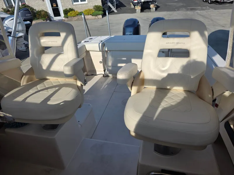 Slide: The Image of Two comfortable, cushioned captain's chairs on a Grady-White Gulfstream 232 boat, featuring armrests. - 14