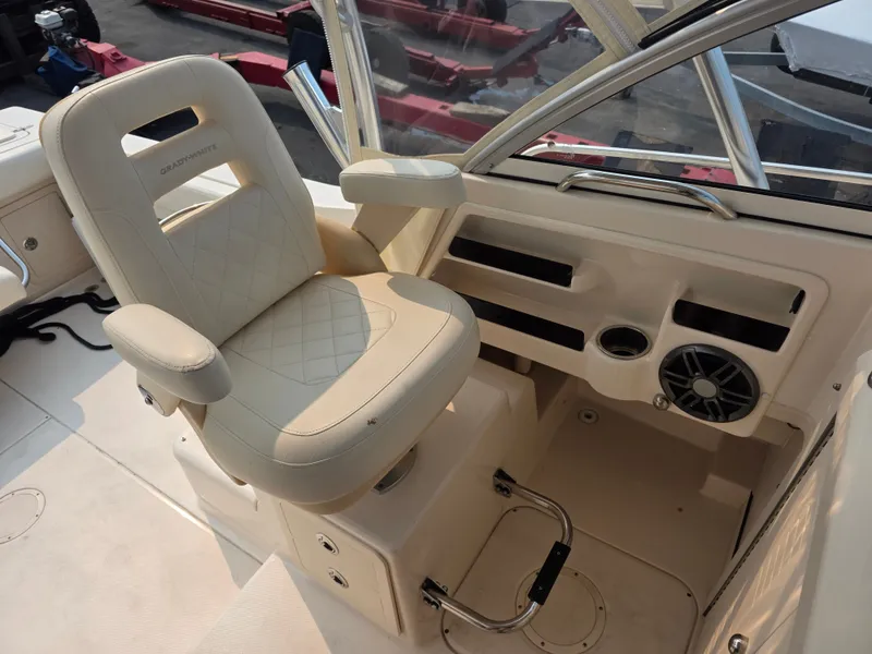 Slide: The Image of The interior of a 2022 Grady-White Gulfstream 232 features a beige captain's chair and helm console. - 14