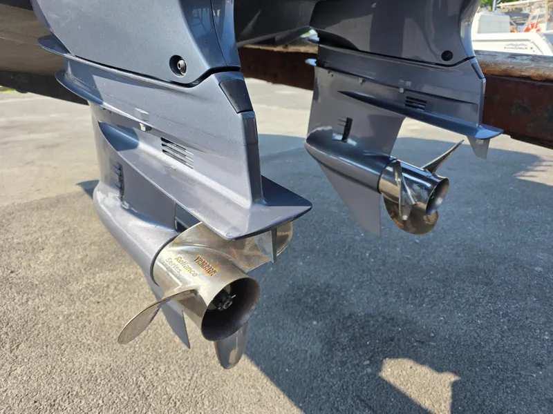 Slide: The Image of Close-up of two outboard motors with shiny propellers on a Grady-White Gulfstream 232. - 26