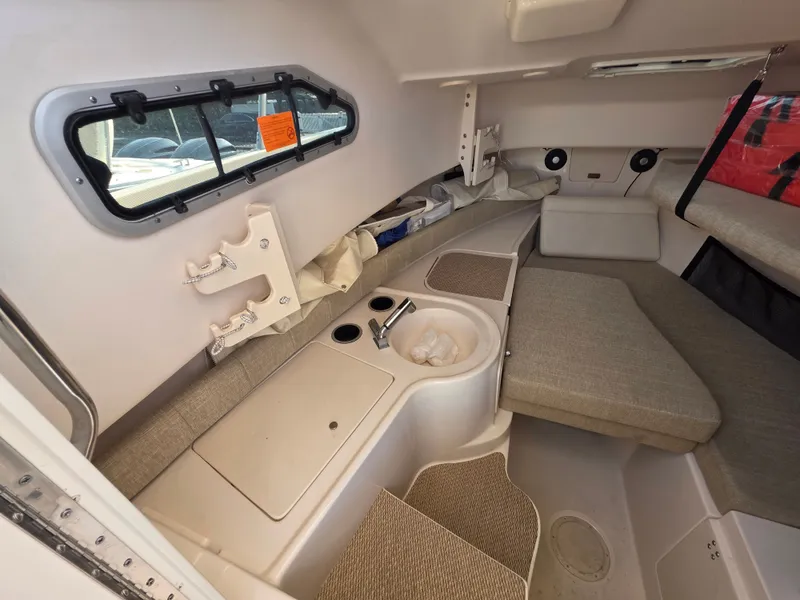 Slide: The Image of Interior of a 2022 Grady-White Gulfstream 232 with cushioned seating and storage space. - 19