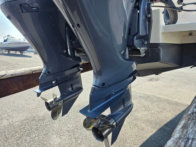 Slide: The Image of Two outboard motors on a Grady-White Gulfstream 232 boat, on a trailer on land. - 27