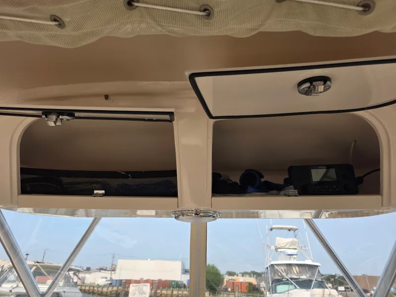 Slide: The Image of The image shows the interior of a Grady-White Gulfstream 232 boat with storage and electronics. - 15