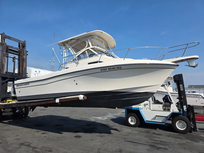 Slide: The Image of A 2022 Grady-White Gulfstream 232 boat is being transported on a trailer. It features a hardtop. - 1