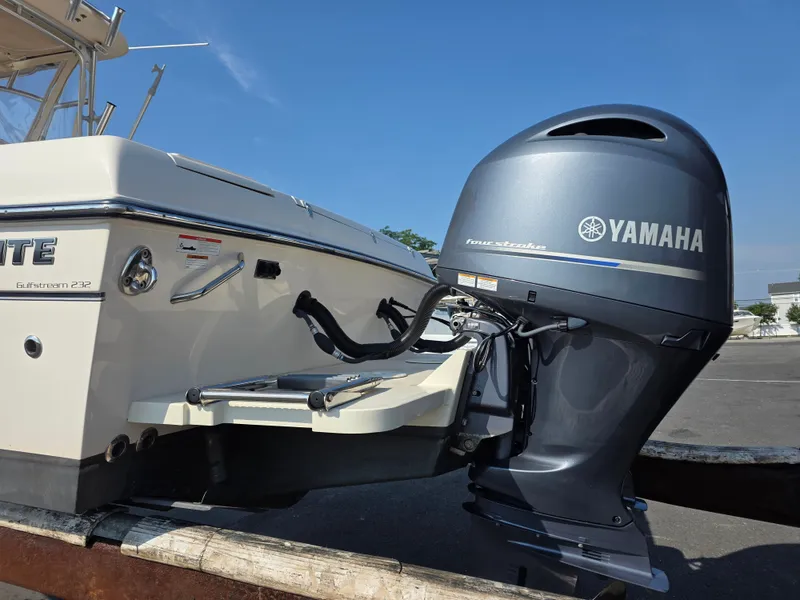 Slide: The Image of A Grady-White Gulfstream 232 boat with a Yamaha outboard motor, parked on a trailer. - 24