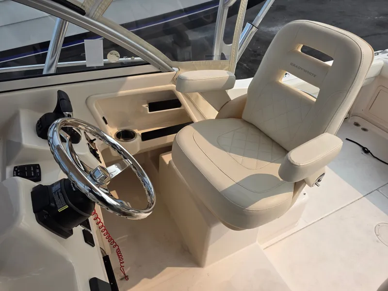Slide: The Image of The image shows the helm of a 2022 Grady-White Gulfstream 232 with a beige captain's chair. - 13