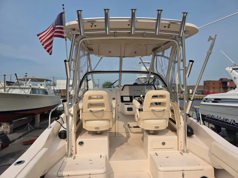 Slide: The Image of The image shows the cockpit of a 2022 Grady-White Gulfstream 232 boat with two seats and a helm. - 5