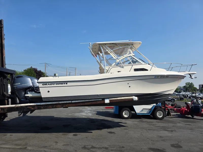 The Image of A 2022 Grady-White Gulfstream 232 boat on a trailer, featuring a Yamaha outboard motor. - 0