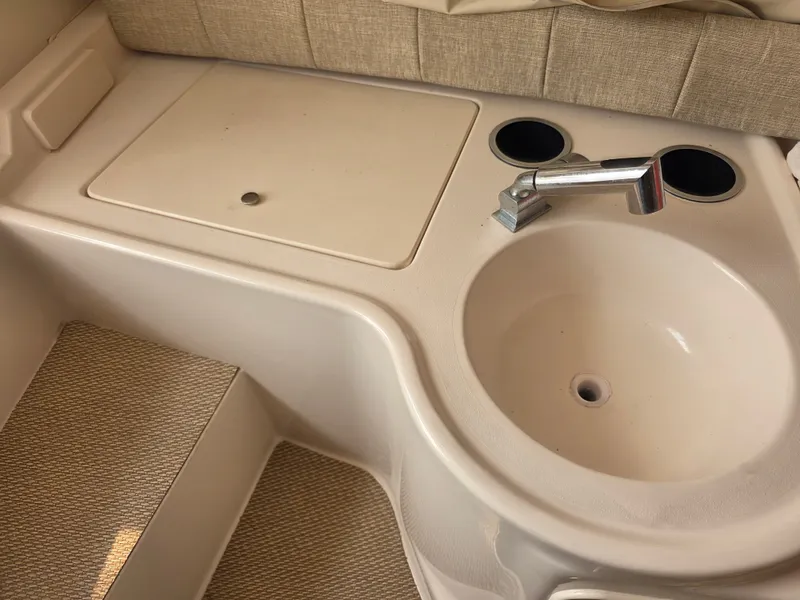 Slide: The Image of The image shows a sink with a faucet and cover in a boat, surrounded by beige upholstery. - 21