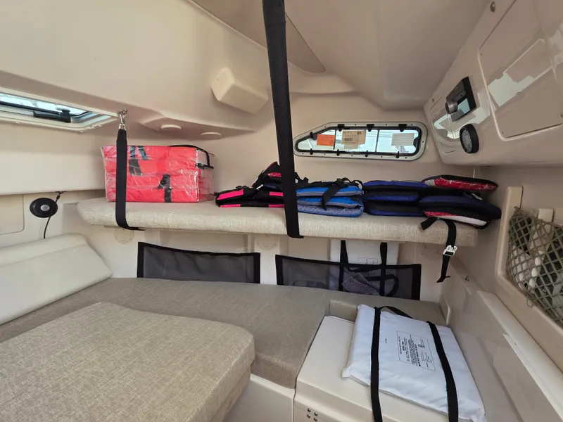 Slide: The Image of Interior of a Grady-White Gulfstream 232 with cushioned seating and safety equipment. - 22