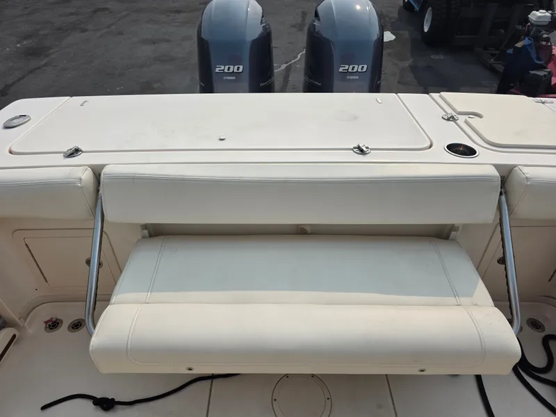 Slide: The Image of The 2022 Grady-White Gulfstream 232 features a cushioned bench seat and two outboard engines. - 7