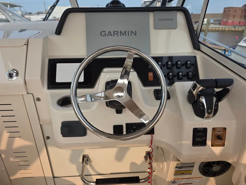 Slide: The Image of The image shows the helm of a Grady-White Gulfstream 232 boat with a Garmin navigation system. - 8