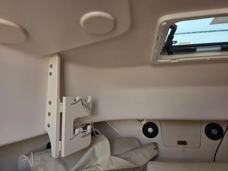 Slide: The Image of Interior of a 2022 Grady-White Gulfstream 232 with storage and a porthole. - 21