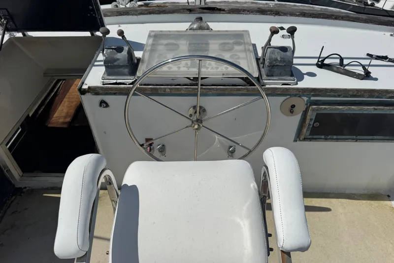 Slide: The Image of Cockpit of 1981 Broward 72 Motor Yacht with steering wheel and controls. - 13