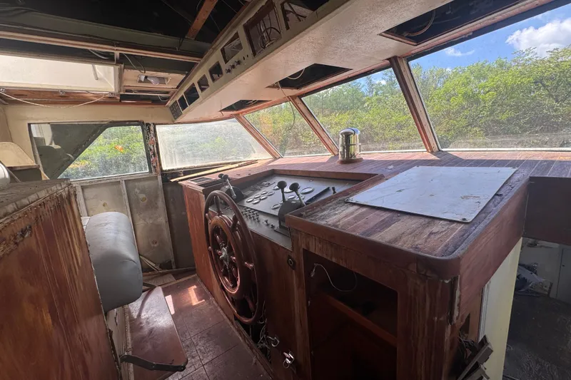 Slide: The Image of Cockpit of a 1981 Broward 72 Motor Yacht with vintage wooden controls and panoramic windows. - 12