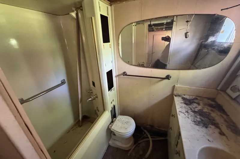 Slide: The Image of Bathroom interior of 1981 Broward 72 Motor Yacht, featuring shower, toilet, and mirror. - 40