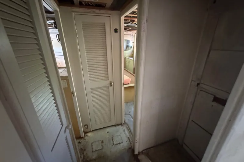Slide: The Image of Interior hallway of a 1981 Broward 72 Motor Yacht with louvered doors. - 36