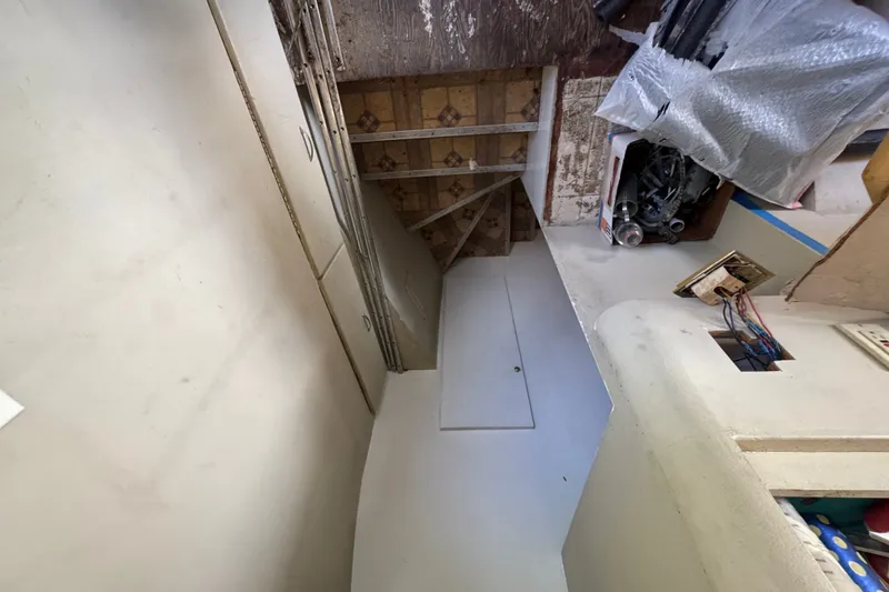 Slide: The Image of Interior view of a 1981 Broward 72 Motor Yacht, showing storage and electrical components. - 20