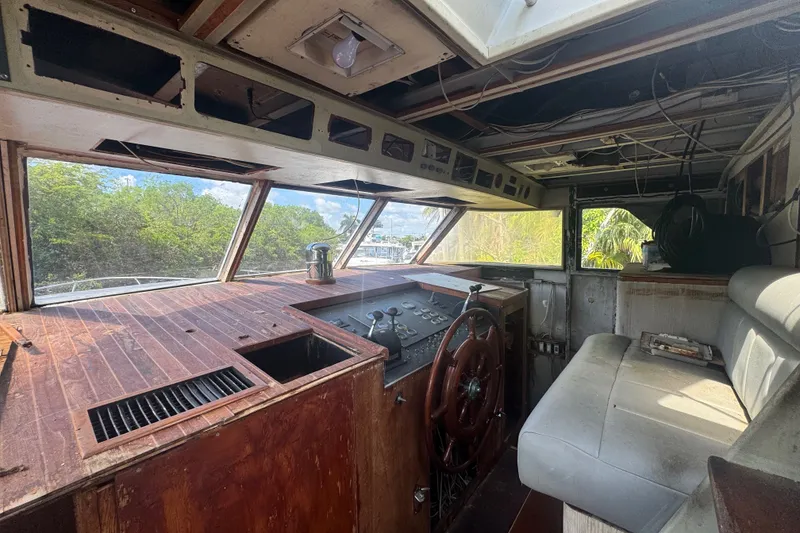 Slide: The Image of Interior of a 1981 Broward 72 Motor Yacht showing the helm and seating area. - 10