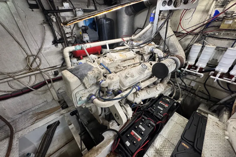 Slide: The Image of Engine room of a 1981 Broward 72 Motor Yacht, showcasing machinery and wiring. - 28