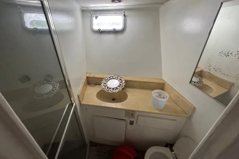 Slide: The Image of Bathroom interior of 1981 Broward 72 Motor Yacht with sink, mirror, and shower. - 24