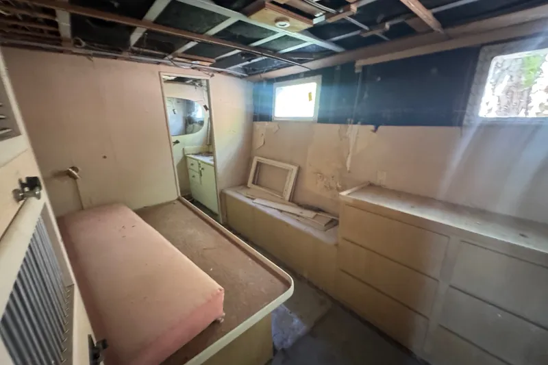 Slide: The Image of Interior of 1981 Broward 72 Motor Yacht showing cabin with bed and storage. - 39