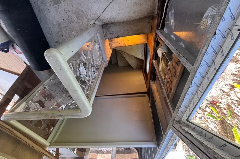 Slide: The Image of Interior view of a 1981 Broward 72 Motor Yacht, showcasing stairs and storage area. - 31