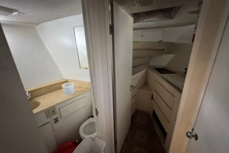 Slide: The Image of Interior of 1981 Broward 72 Motor Yacht bathroom with sink and storage cabinets. - 22