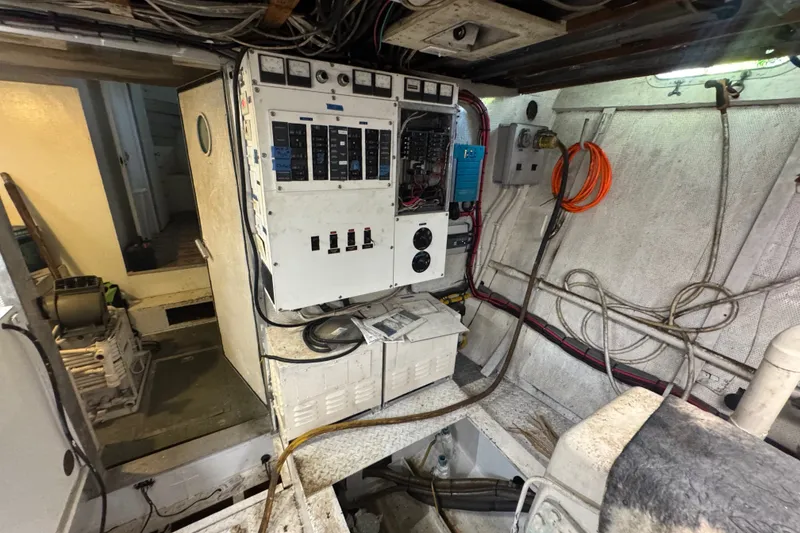 Slide: The Image of Electrical control room of a 1981 Broward 72 Motor Yacht, featuring panels and wiring. - 29
