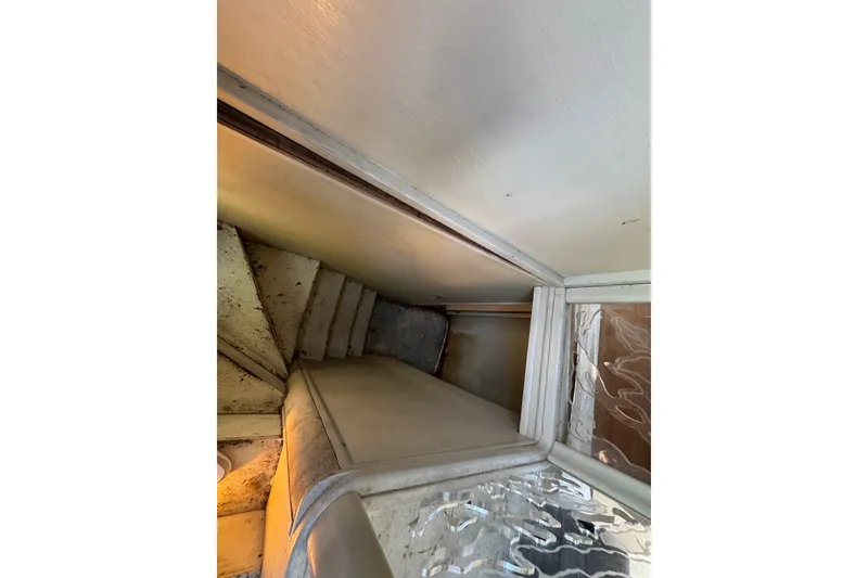 Slide: The Image of Interior view of 1981 Broward 72 Motor Yacht staircase and seating area. - 32