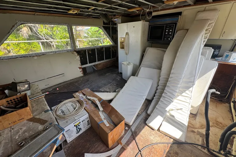 Slide: The Image of Interior of a 1981 Broward 72 Motor Yacht under renovation, with cushions and appliances. - 19
