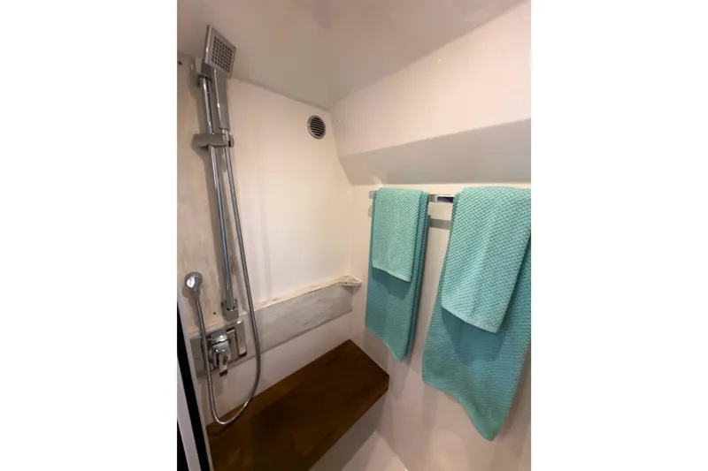 Slide: The Image of Shower area in 2017 Tiara Yachts C39 Coupe with teal towels and modern fixtures. - 21