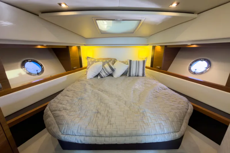 Slide: The Image of Luxurious cabin interior of 2017 Tiara Yachts C39 Coupe with cozy bedding and porthole windows. - 18