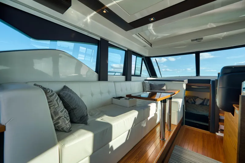 Slide: The Image of Luxurious interior of 2017 Tiara Yachts C39 Coupe with white seating and wooden accents. - 13