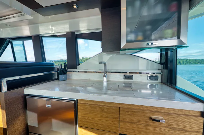 Slide: The Image of Modern kitchen interior of 2017 Tiara Yachts C39 Coupe with sleek countertops and scenic window view. - 15