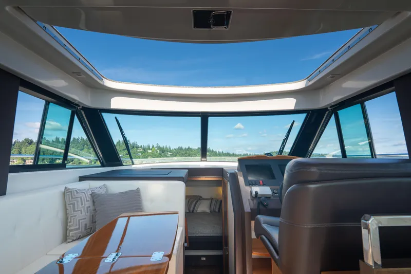 Slide: The Image of Interior view of 2017 Tiara Yachts C39 Coupe with panoramic windows and luxurious seating. - 17
