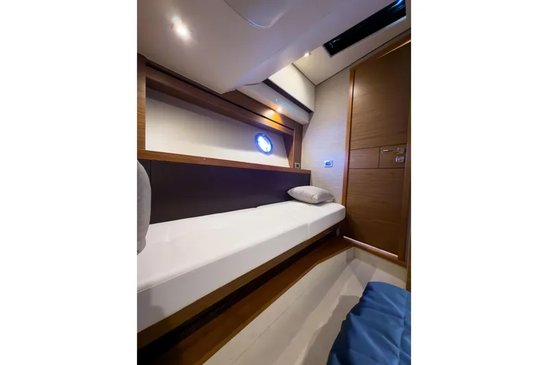 Slide: The Image of 2017 Tiara Yachts C39 Coupe cabin interior with sleek design and cozy bed. - 23