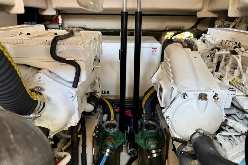 Slide: The Image of Engine room of a 2016 Sea Ray Sundancer 400, showcasing dual engines and mechanical components. - 68